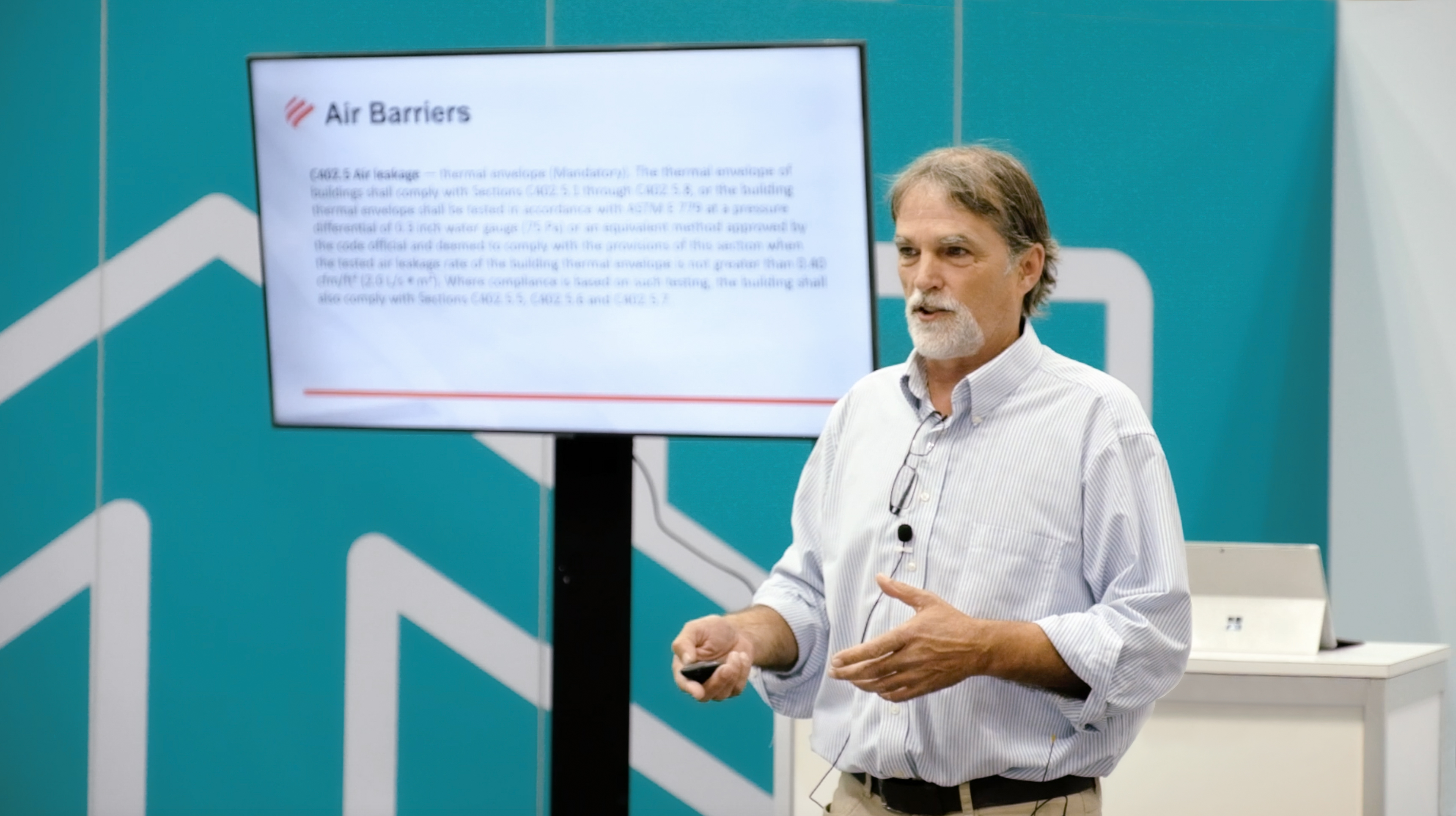 Photo of Bill Beals, The Code Man, giving a presentation about air barrier energy codes